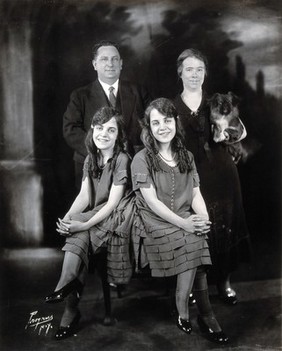 Daisy and Violet Hilton, conjoined twins, with the Meyers, with whom they lived and who managed them. Photograph, c. 1927.