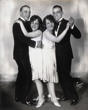 Daisy and Violet Hilton, conjoined twins, dancing with two young men. Photograph, c. 1927.