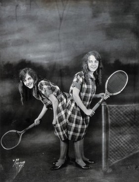 Daisy and Violet Hilton, conjoined twins, ready for tennis. Photograph, c. 1927.