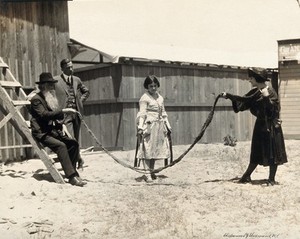 view A girl about to skip using a rope made out of a 17-foot-long beard, belonging to Hans Langseth of North Dakota. Photograph, 192-.