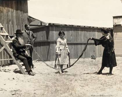 A girl about to skip using a rope made out of a 17-foot-long beard, belonging to Hans Langseth of North Dakota. Photograph, 192-.