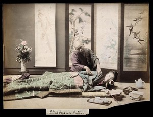 view A Japanese woman being massaged by a blind Japanese masseur. Coloured photograph.
