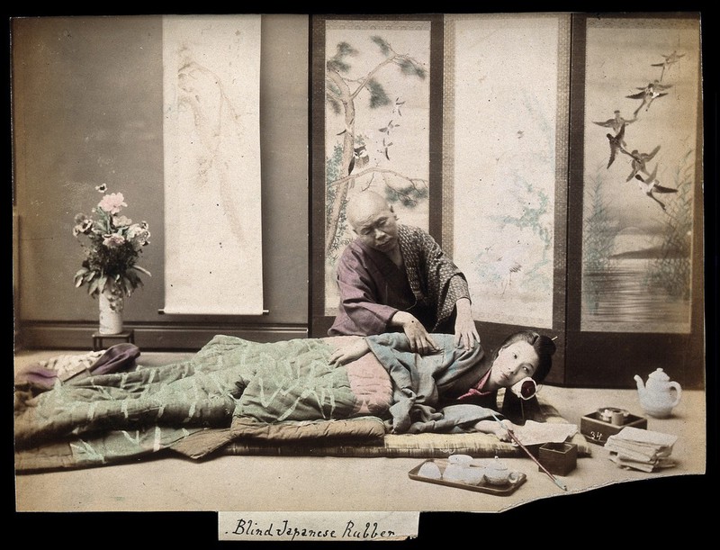 A Japanese woman being massaged by a blind Japanese masseur picture picture