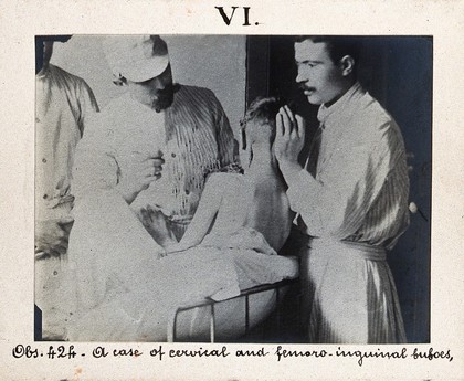 Seamen's Hospital for infectious diseases in Jurujuba, Rio de Janeiro; a plague patient in bed, viewed from behind, his head supported by a member of the medical team. Photograph, 1904/1911.