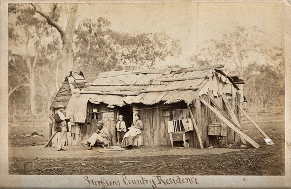 Doctor Smith, an Australian surgeon, sitting outside a shack, reading a book. Photograph by T.J. Washbourne, ca. 1870/1888.