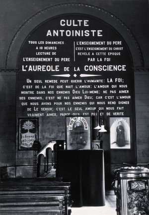 view Temple of the Antoinistes, Liège: the chancel end showing the tenets of the cult marked on the wall in large letters. Photograph by Kurt Lubinski, 1920/1940 (?).