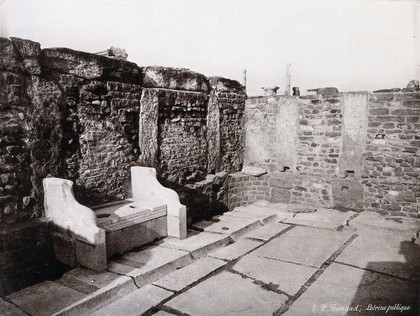 Timgad, North Africa: latrines in an excavated ancient ruin. Photograph by F.P. (?), ca. 1900 (?).