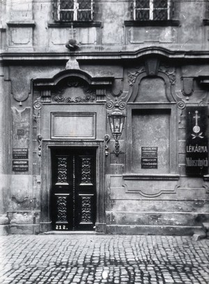 view An ornate doorway into a large stone building used as a dispensary in Prague. Photograph by Z. Reach.