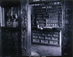 view Landesmuseum, Zürich: reconstruction of a seventeenth-century apothecary's shop with carved wooden entrance, in the. Photograph.