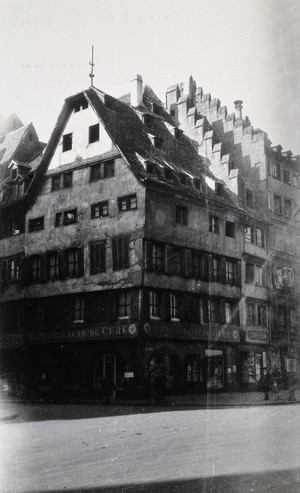 view The Pharmacie du Cerf and surrounding buildings, Strasbourg. Photograph.