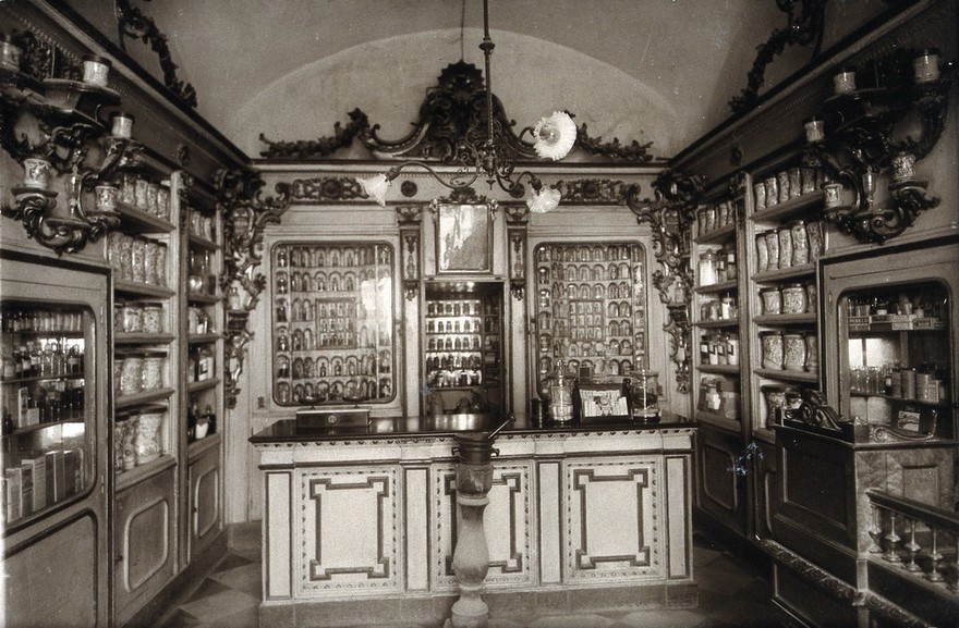 The ornate sixteenth-century pharmacy of S. Maria della Scala, Sorrento: interior with decorated bench and a large mortar in centre. Photograph.