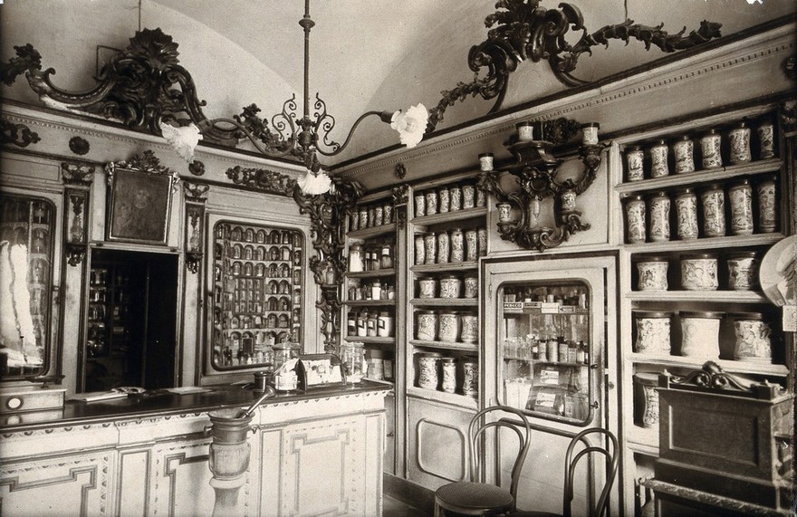 An ornate sixteenth-century pharmacy of S. Maria della Scala, Sorrento: right corner of interior showing decorated pharmacy jars on shelves. Photograph.