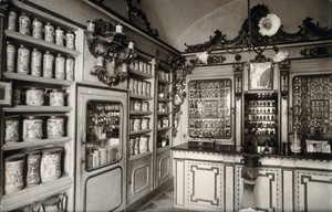 view The ornate sixteenth-century pharmacy of S. Maria della Scala, Sorrento; left corner of interior showing decorated pharmacy jars on shelves. Photograph.