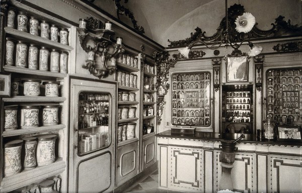 The ornate sixteenth-century pharmacy of S. Maria della Scala, Sorrento; left corner of interior showing decorated pharmacy jars on shelves. Photograph.