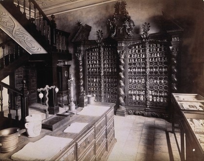 An eighteenth-century apothecary's shop with intricately carved wooden showcases; recreated for the Deutsches Museum in Nürnberg. Photograph.