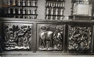 view A seventeenth-century wooden pharmacy counter carved in low relief, the central panel is of an elephant. Photograph.