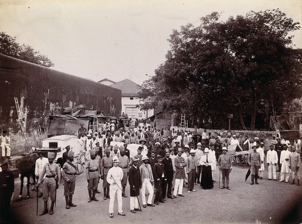 A group comprising doctors, health and public officials gathered on a street in Bombay about to begin the day's work, during an outbreak of plague. Photograph, 1896/1897.