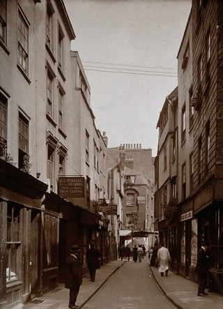 The church of St. Bartholomew the Great and surrounding area; looking east down the eastern end of a street known as Cloth Fair. Photograph by W.F. Taylor, August 1914.