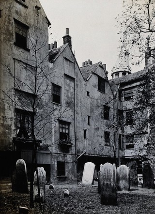 The church of St. Bartholomew the Great and surrounding area; the back of the houses on Cloth Fair with gravestones in the ground. Photograph by Rev. C.F. Fison, November 10th 1914.