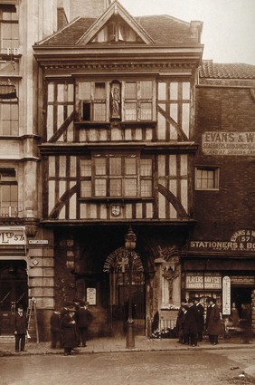 The church of St. Bartholomew the Great and surrounding area; the entrance to the church at West Smithfield. Photograph by W.F. Taylor.