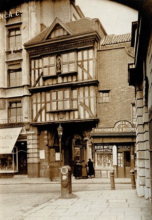 view The church of St. Bartholomew the Great and surrounding area; the entrance to the church at West Smithfield. Photograph by Rev. C.F. Fison.