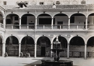 view Hospital San Juan de Diós, Granada: view of the cloister and fountain . Photograph, ca.1900.