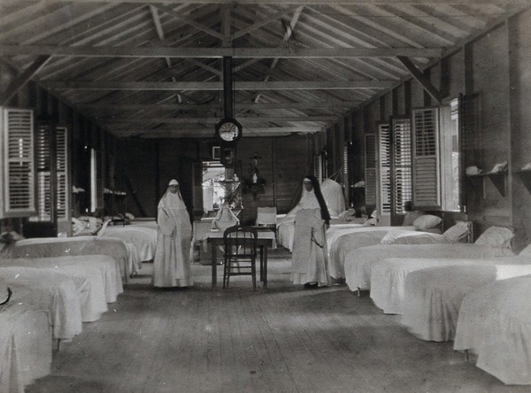 An eye hospital (?), Trinidad: a ward with two nuns. Photograph, 1910/1930 (?).