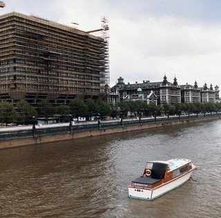 St. Thomas' Hospital, London, England: exterior view showing scaffolding on the building and the River Thames in the foreground. Photograph by H. Windsley, 1972.