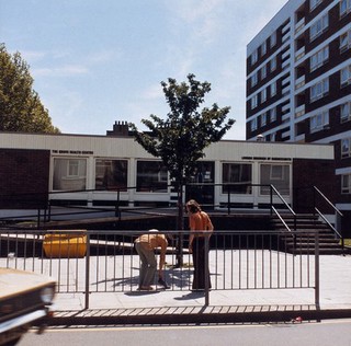 The Grove Health Centre, Hammersmith, London, England: exterior; a couple in the foreground. Photograph by H. Windsley, 1972.