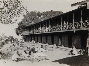 view The Pasteur Institute Hospital, Kasauli, India: Indian patients outside the accommodation building. Photograph, ca. 1910.