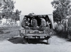 view Malaria control campaign truck: view of rear with soldiers sitting in the back. Photograph, 1940/1950 (?).