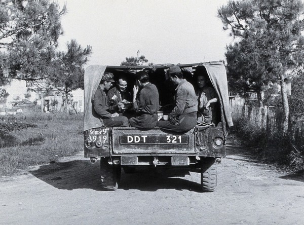 Malaria control campaign truck: view of rear with soldiers sitting in the back. Photograph, 1940/1950 (?).