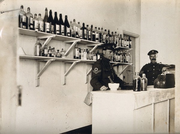 Military dispensary with two R.A.F. medical officers; interior. Photograph, ca. 1945 (?).