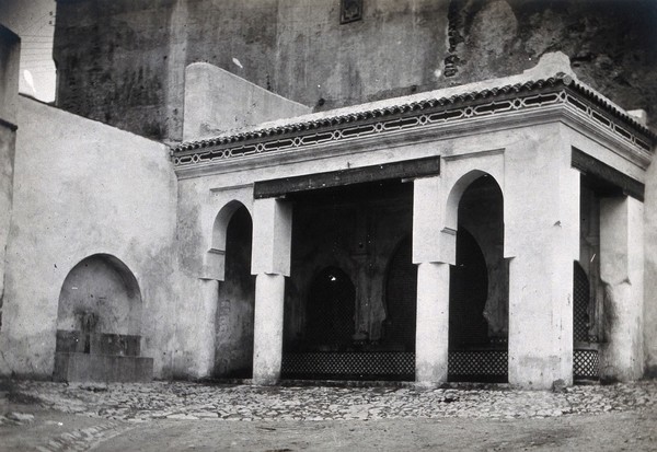 The feeding trough, restored, inside the walls of the Bab al-Guissa Mosque, Fez, Morocco. Photograph, ca. 1922.