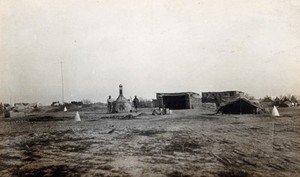 view The Tigris Front, Iraq (formerly Mesopotamia): First Corps British Army camp sanitary area at Sandy Ridge: view of closed incinerator, sweeper's tent, drying shed for litter and latrine huts. Photograph by P.F. Gow, ca. 1916.