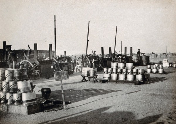 Moascar, Ismailia, Egypt (Suez Canal area): the New Zealand military camp open air kitchen: rows of large metal cooking pots (known as dixies). Photograph, 1914/1918 (?).