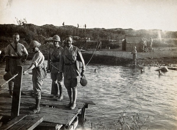 Auja River, near Mulebbis, Israel: soldiers bathing or standing on a wooden jetty. Photograph, 1914/1918 (?).