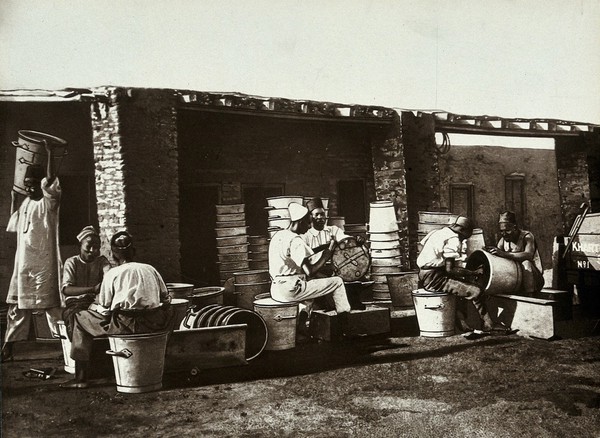 The Khartoum Sanitary Service: Sudanese men repairing buckets, Khartoum, Sudan. Photograph, ca. 1911.