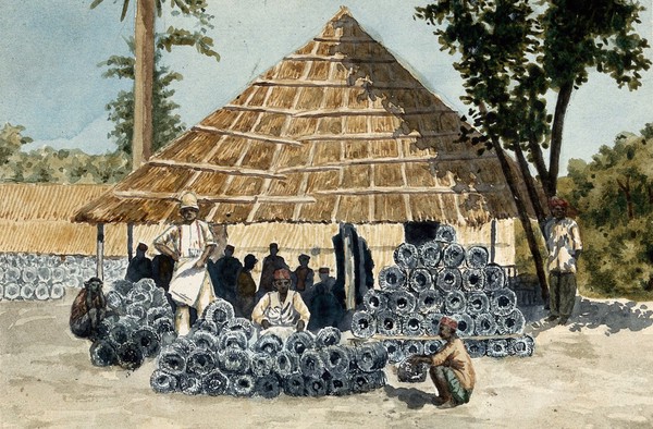 India: metal rodent traps in a pile; the rat-catchers gather under a grass-roofed shelter to be paid. Watercolour by E. Schwarz-Lenoir, 1915/1935 (?).