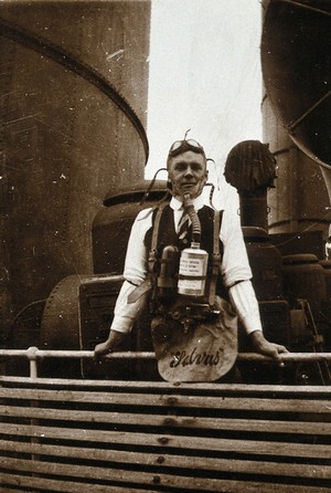 view Ship fumigation using hydrogen cyanide: an operator wearing protective oxygen breathing apparatus. Photograph by P. G. Stock, 1900/1920.