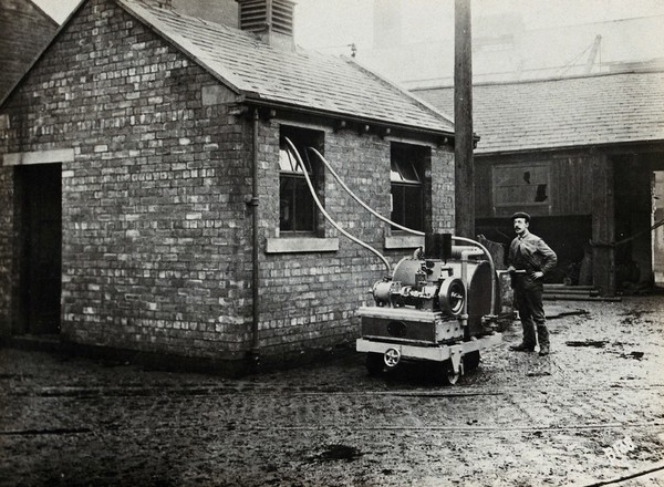 Fumigating a building (to destroy typhus-carrying lice ?) with the Clayton Type B machine, England (?). Photograph, 1910/1930.