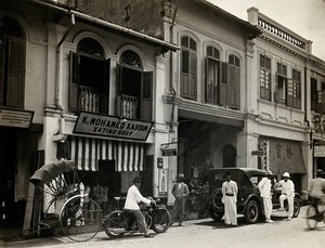 view Kuala Lumpur, Malaysia: busy street scene showing the K. Mohamed Kassim eating house where a case of typhus occurred. Photograph, 1915/1925.