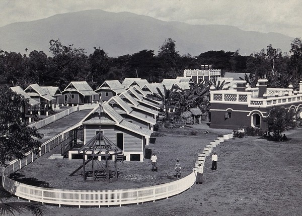 Patton village, Chiengmai Leper Asylum, Thailand: view of cottages with mountains in the background. Photograph, 1921.