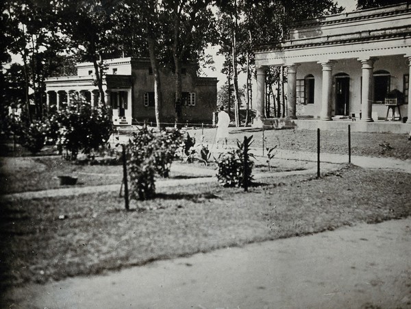 Purulia Leper Home and Hospital, Bihar, India: view of large hospital buildings with pillars: the men's hospital and the tuberculosis ward. Photograph, 1890/1920.