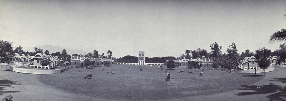 Chiengmai Leper Asylum, Thailand: view showing a water tower (centre), Stoner village cottages (right) and Patton village cottages (left). Photograph, ca. 1921.