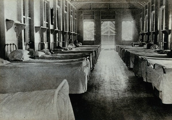 Leper asylum, Port of Spain, Trinidad: rows of empty beds in a hospital ward. Photograph, 1890/1910.