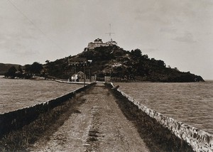 view Leper asylum, Rat Island, Antigua: view of the causeway and the asylum building on top of the island. Photograph, 1890/1910.