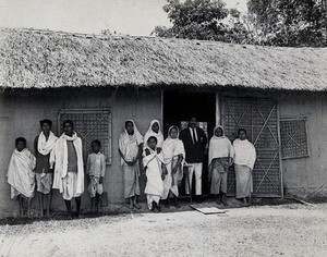 view Golaghat, India: kala-azar patients with a doctor (?), outside a field laboratory. Photograph, 1900/1920 (?).