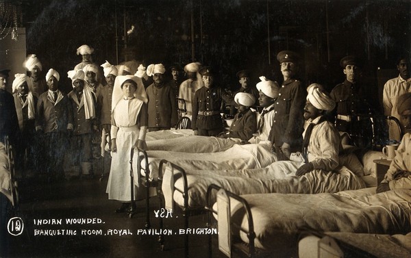 World War One: convalescent Indian soldiers with British military medics and a nurse in a ward in the Royal Pavilion, Brighton. Photograph, 1914/1918.