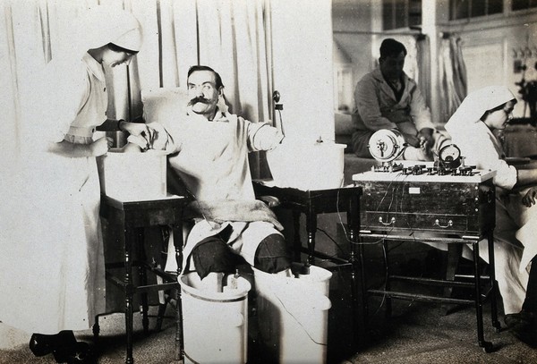 The Royal Hospital, Haslar, England: a wounded patient having a galvanic 'four-cell' bath. Photograph, 1914/1918.